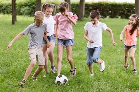 Niños y niñas jugando al fútbol